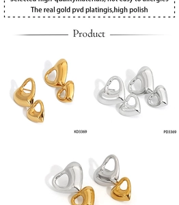 Detail of PVD gold and silver heart earrings showing high polish finish and craftsmanship