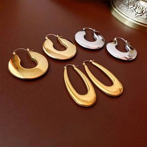 Polished U-shaped and oval stainless steel hoop earrings in gold and silver finish
