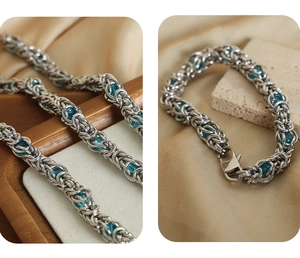 Detailed view of silver punk chain bracelet with blue beads on a textured background