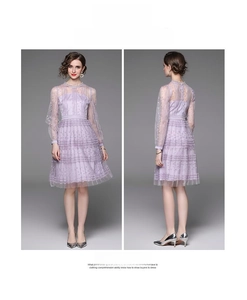 Close-up of purple lace dress with floral embroidery and mesh long sleeve details