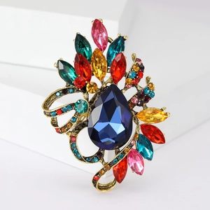 Macro shot of vintage crystal brooch with colorful rhinestones and teardrop blue gem