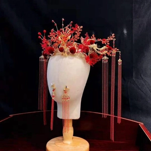 Chinese bridal headpiece and earrings with red and gold floral tassels on mannequin