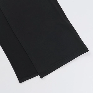 Detail view showing professional flat seam stitching and side slit on black dress