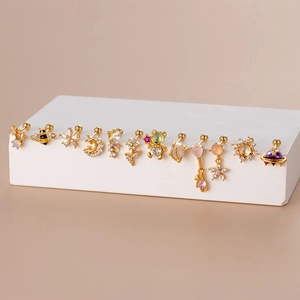 Collection of gold stainless steel stud earrings featuring zircon moon and star designs