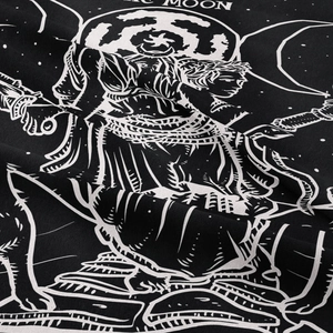 Detail showing the moon and star pattern printed on a black bohemian wall tapestry