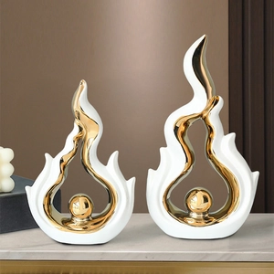 Modern white and gold abstract ceramic fire sculpture set for home decor on marble