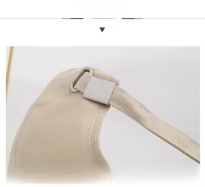 Detail view of the adjustable metal buckle and beige canvas strap on a baseball cap