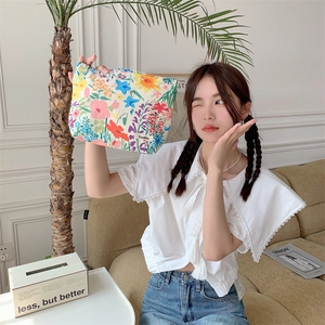 Detailed view of large floral fabric cosmetic bag with zip and Sozakka brand tag