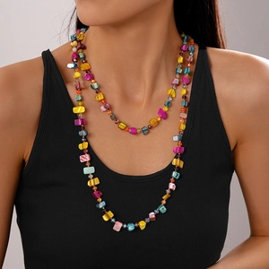 Detail of bohemian layered necklace with colorful irregular beads on model