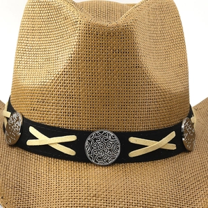 Close-up of straw cowboy hat featuring a black band with silver swirl metal buckles