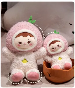 Detail showing two sizes of plush peach dolls with soft fur and green leaf decorations