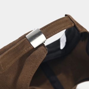 Adjustable silver metal buckle and strap on brown cotton baseball cap for custom fit