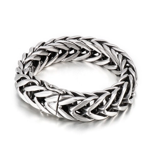 Men's punk style silver stainless steel V-shaped woven chain bracelet on grey background