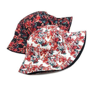 Floral print bucket hats in black and white with reversible sun protection design