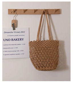 Detailed macro shot of the hollow-out cotton rope mesh weave on a beige shoulder bag