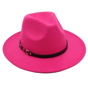 Detail of fuchsia wool fedora hat with black leather band and gold buckle accent