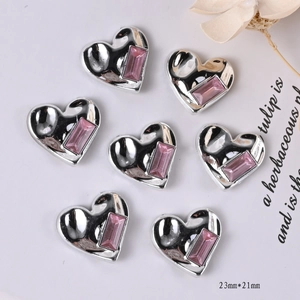 Detail showing heart-shaped silver metal charms with pink zircon inlay and 23mm size