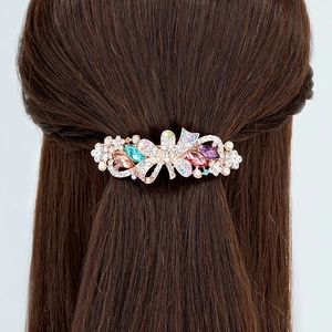 Elegant gold bow flower spring hair clip with colorful crystals on model hair