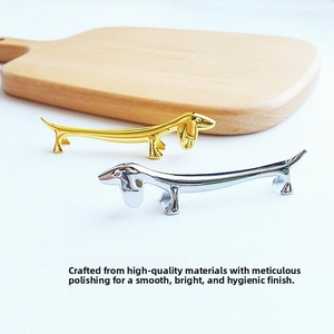 Polished dachshund metal chopstick rest set in gold and silver on wood