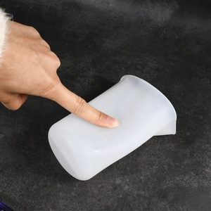 Detailed view of flexible 120ml silicone measuring cup showing scale marks and soft material