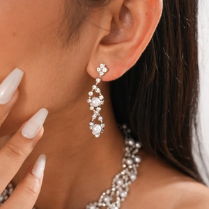 Close-up of double-layer flower necklace with rhinestones and faux pearls on model