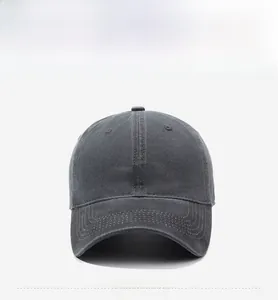 Detailed close-up of white COYENRAT letter embroidery on dark gray washed cotton baseball cap
