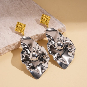 Bold two-tone irregular geometric metal earrings with hammered gold and silver textures
