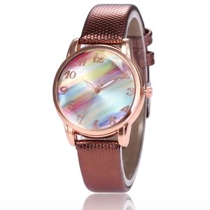 Detail of rose gold quartz watch featuring rainbow dial and brown lizard pattern leather strap