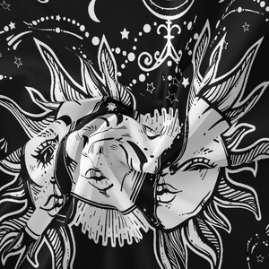 Detailed view of celestial sun and moon patterns on a bohemian woven tapestry fabric