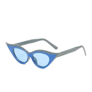 Cat eye sunglasses featuring grey and blue layered frames with blue tinted lenses