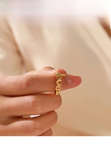 Macro shot of 18K gold plated LOVE cutout ring showing elegant hollow letter details