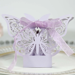 Close-up of laser-cut light purple butterfly candy box with silk ribbon decoration