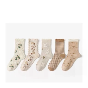 Five pairs of floral and rabbit embroidered knit crew socks in warm beige and brown tones