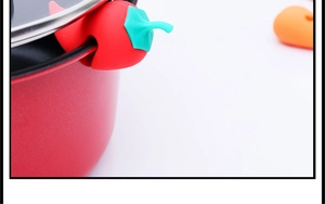 Macro detail of red chili silicone lid lifter preventing boil-over on a red cooking pot