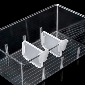 Detail view of adjustable plastic refrigerator drawer dividers and storage clip assembly