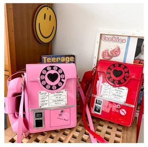 Creative telephone shaped crossbody bags in glossy pink and red with retro hotline design