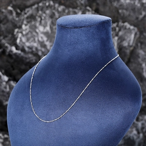 Silver dainty chain necklace displayed on a dark velvet bust for a luxury look