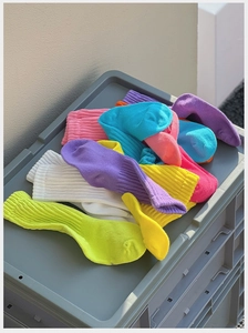 Vibrant colorful ribbed cotton crew socks in neon green, yellow, and blue stack