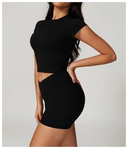 Side view of black cropped sports top and high-waisted shorts with seamless stitching