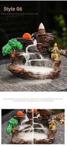 Zen backflow incense burner showing mountain landscape with golden pavilion and flowing smoke
