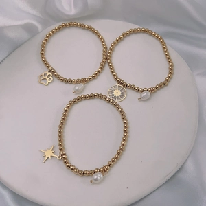 Three-piece 18k gold plated beaded stretch bracelets with pearl and star charms