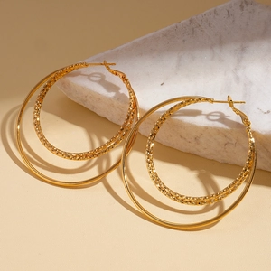 Detail of 18k gold plated triple layer hoop earrings on a marble display