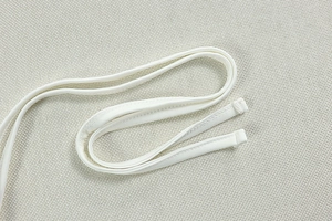 Detailed close-up of white thin straps and fine texture on a bodycon cutout dress