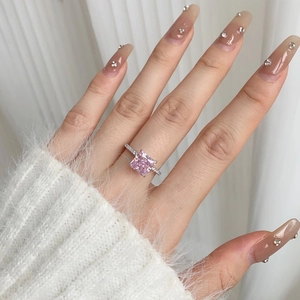 Detailed shot of S925 sterling silver ring with princess cut pink stone on hand