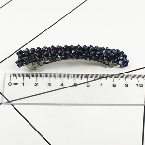 Detailed view of 9.5cm dark blue crystal beaded spring hair clip with silver metal base