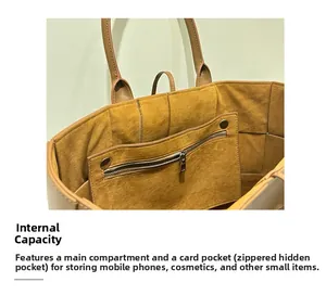 Top view of spacious interior in leather woven tote with brown suede lining and zip pocket