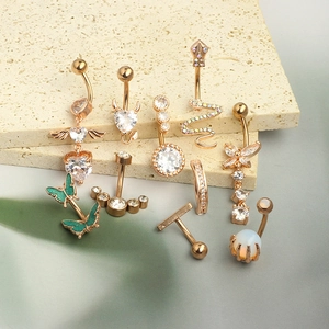 Detailed set of rose gold belly rings featuring zircon hearts, snakes, and opal butterflies