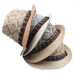 Detail of woven straw fedora hats featuring ethnic embroidered jacquard decorative bands