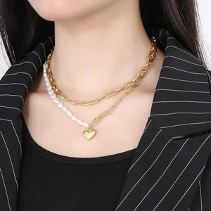 Close-up of double-layer gold necklace with freshwater pearl stitching and heart pendant