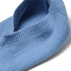 Detailed close-up of blue knitted beanie scarf cuff texture and ribbed weaving pattern